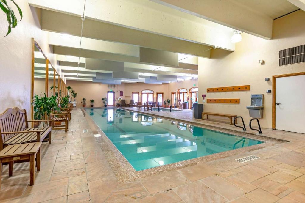 a large swimming pool in a building with benches and chairs at Charter at Beaver Creek E125 studio in Beaver Creek