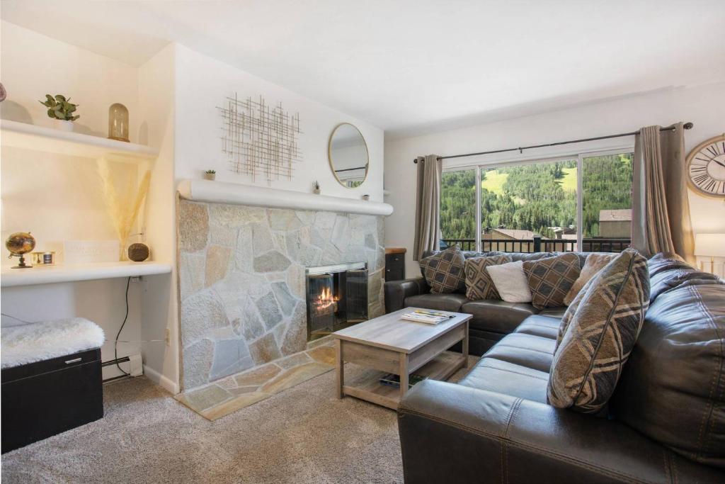a living room with a couch and a fireplace at Vantage Point 403 in Vail