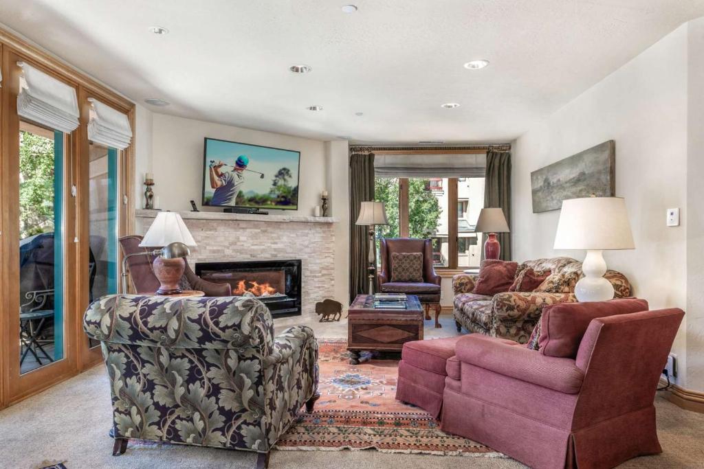 a living room filled with furniture and a fireplace at Beaver Creek Lodge 411 in Beaver Creek