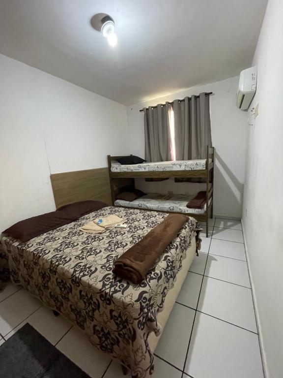 a small room with a bed and atained at Shopping Campos Boulevard in Campos dos Goytacazes