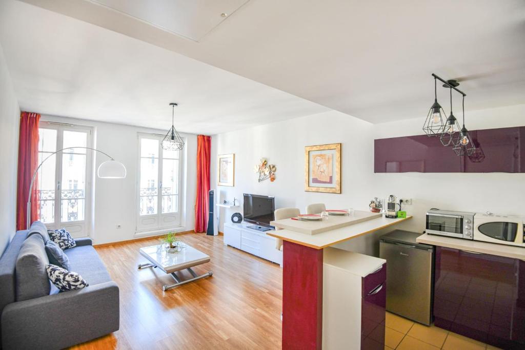 une cuisine et un salon avec un canapé et une table dans l'établissement Les Dames - Bel appart 1 ch hypercentre, à Marseille