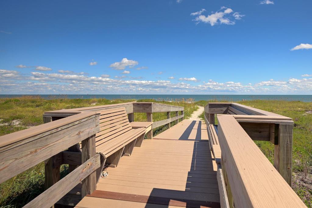 a wooden boardwalk leading to the beach at Fully Updated, Ground Floor, Poolside With Great Ocean View - Unit 49! in Cocoa Beach