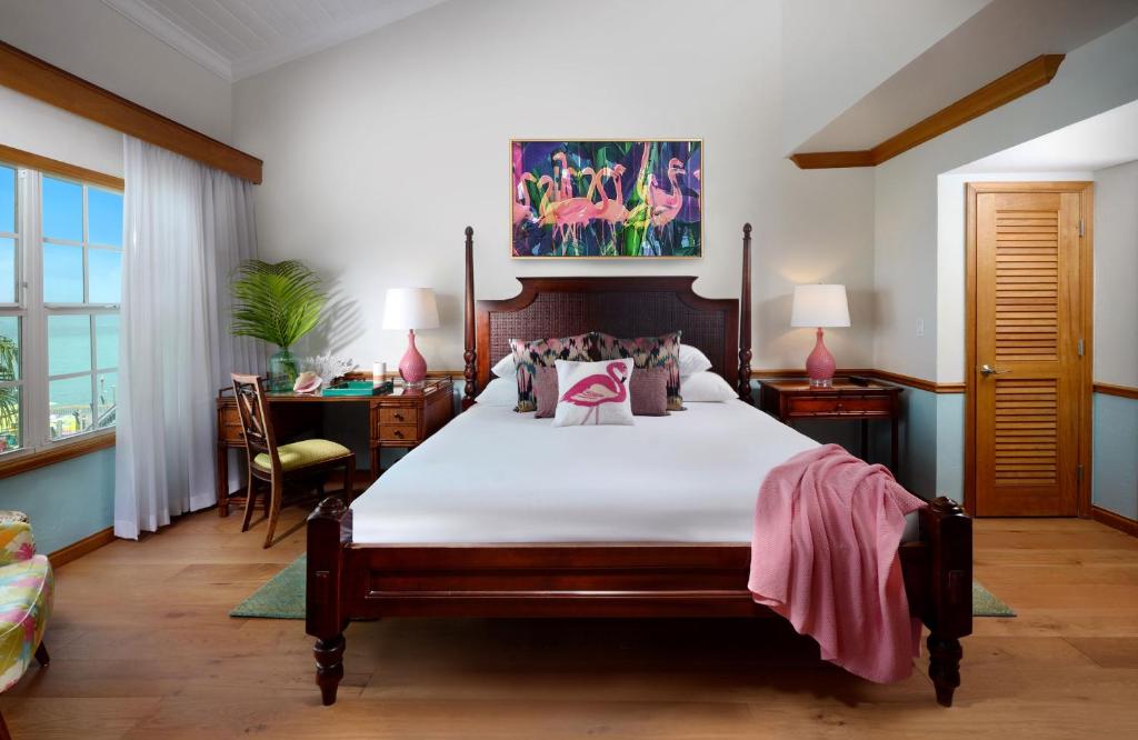 a bedroom with a bed and a desk at Ocean Key Resort & Spa, a Noble House Resort in Key West