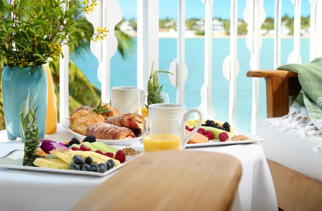 a table with two plates of food and juice at Ocean Key Resort & Spa, a Noble House Resort in Key West