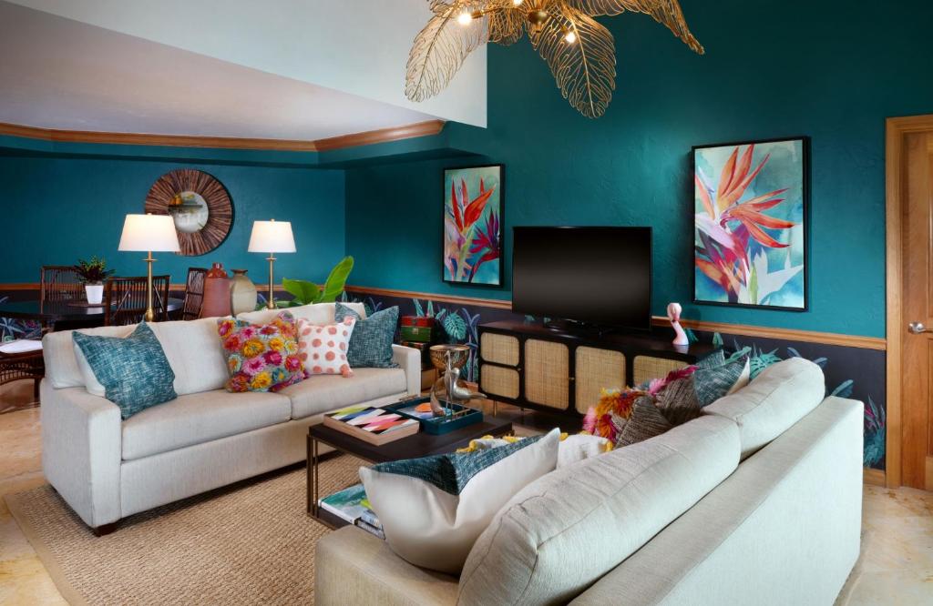 a living room with two couches and a tv at Ocean Key Resort & Spa, a Noble House Resort in Key West