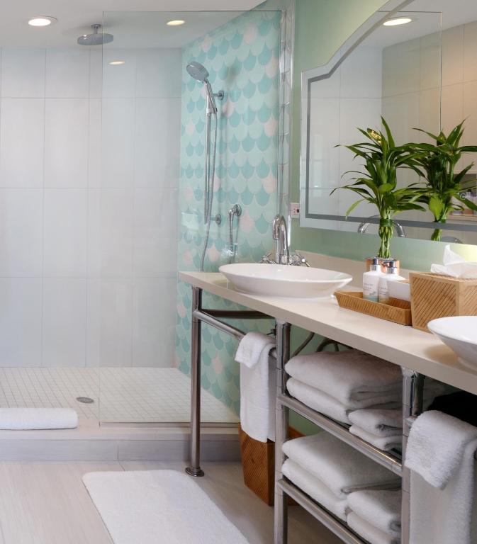 a bathroom with a sink and a shower at Ocean Key Resort & Spa, a Noble House Resort in Key West