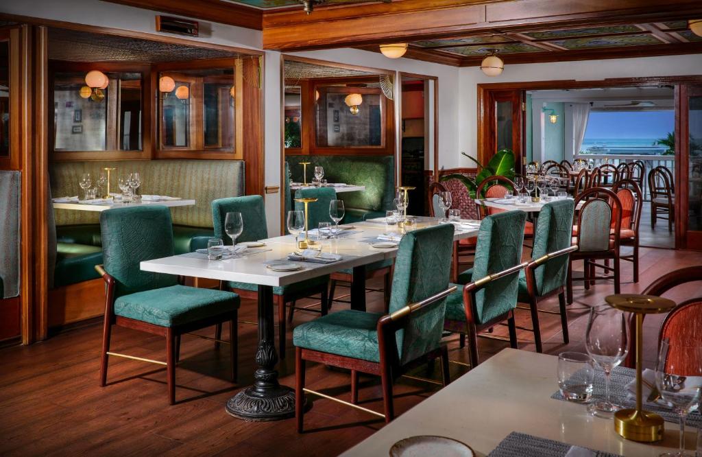 a restaurant with tables and chairs with wine glasses at Ocean Key Resort & Spa, a Noble House Resort in Key West