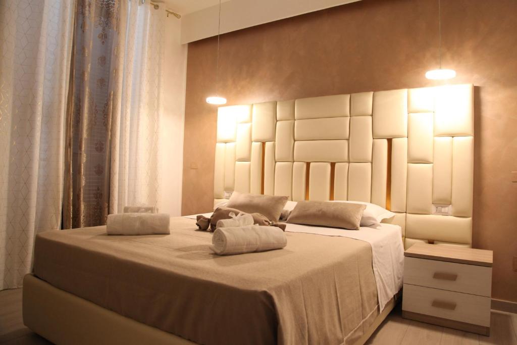 a bedroom with a large bed with two towels on it at Royal Dreams in Caserta