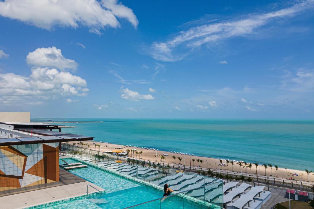 a view of a beach with chairs and the ocean at Praiano Hotel in Fortaleza