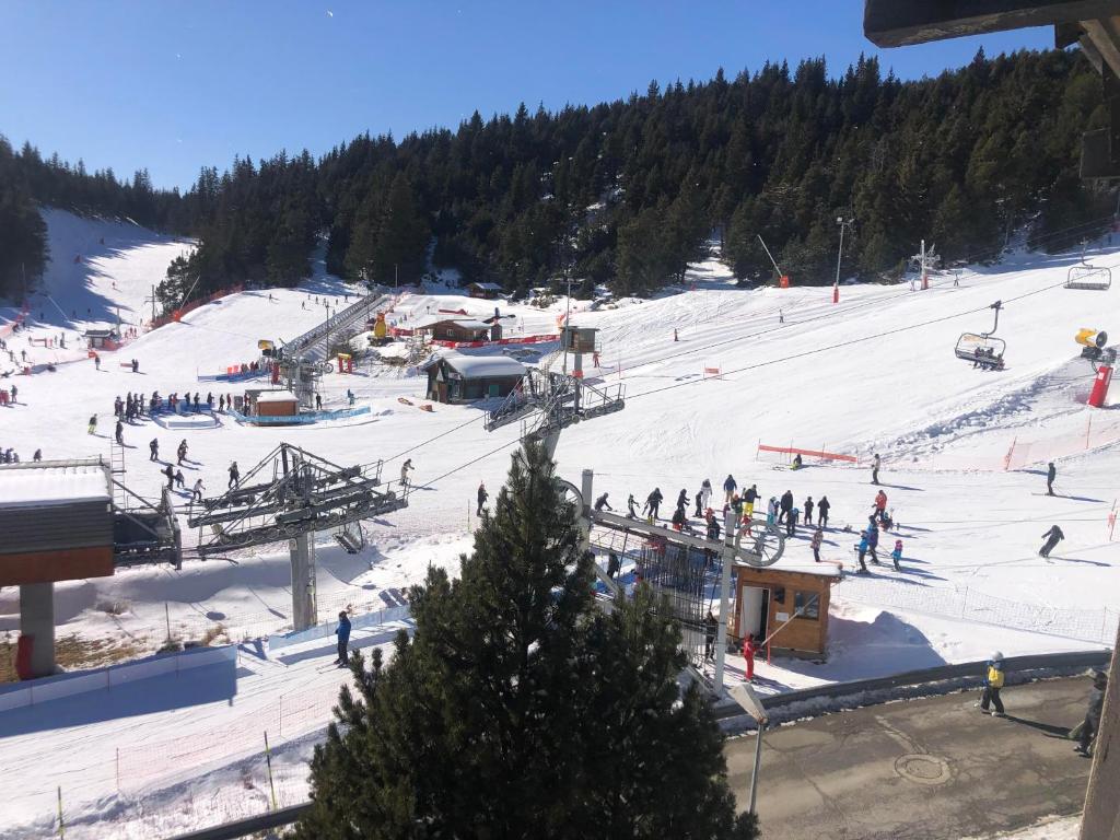 a group of people skiing on a ski slope at Studio Cabine Chaleureux 4 Personnes Pied des Pistes Pyrénées 2000 in Bolquere Pyrenees 2000