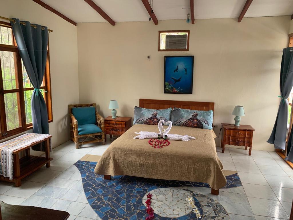 a bedroom with a bed with two towels on it at Casa Verde Vacation Garden Home in San Cristobal