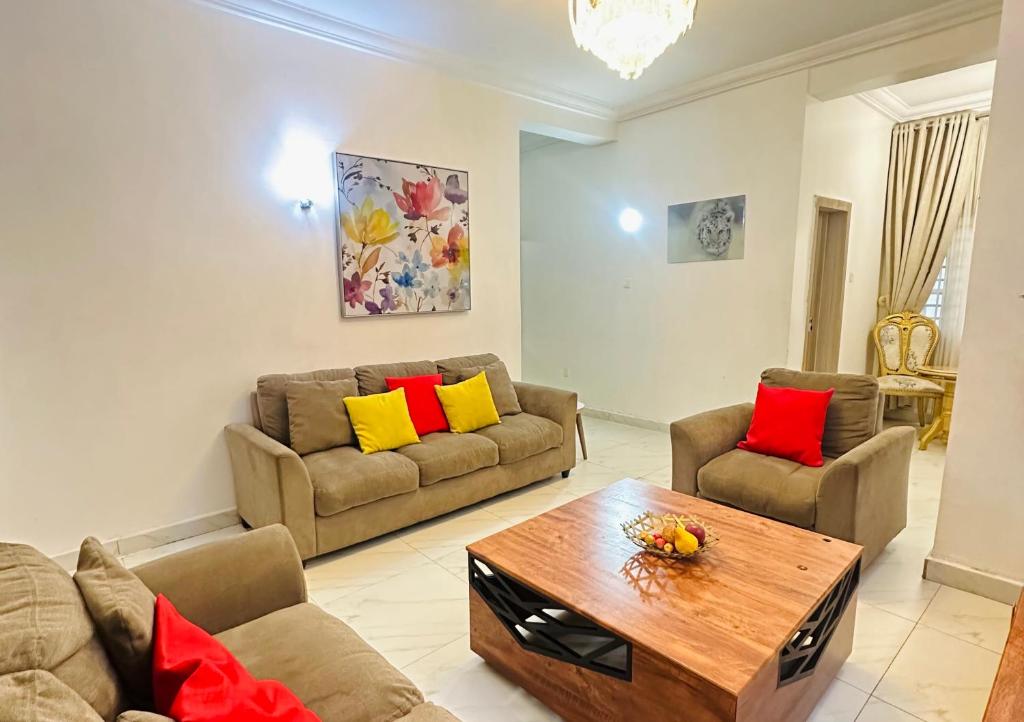 a living room with two couches and a coffee table at Exotic 2 BR Apartment at Wuye, Abuja - Wifi,Netflix in Abuja