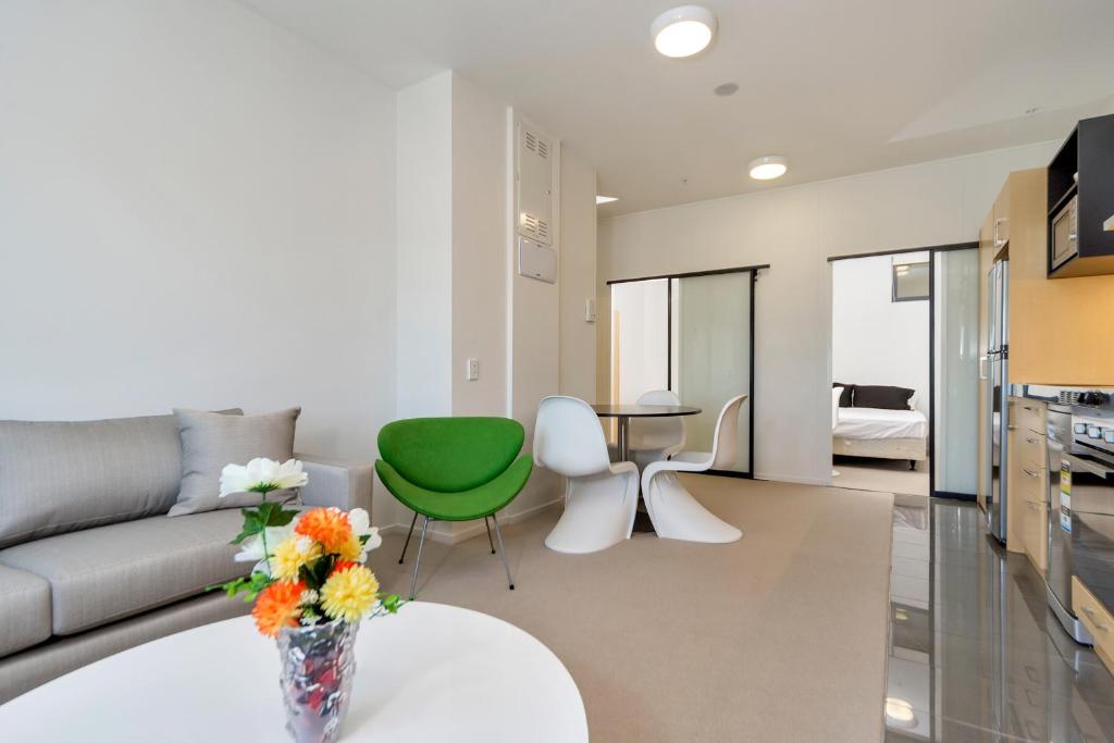 a living room with a couch and a table at MCentral Apartments Manukau in Auckland