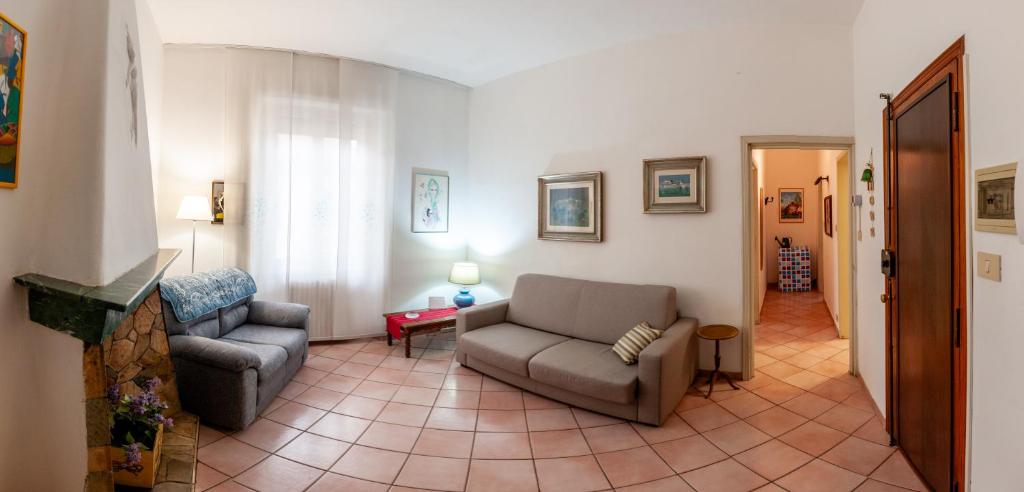 - un salon avec un canapé et une chaise dans l'établissement Appartamento Margaritone, à Arezzo