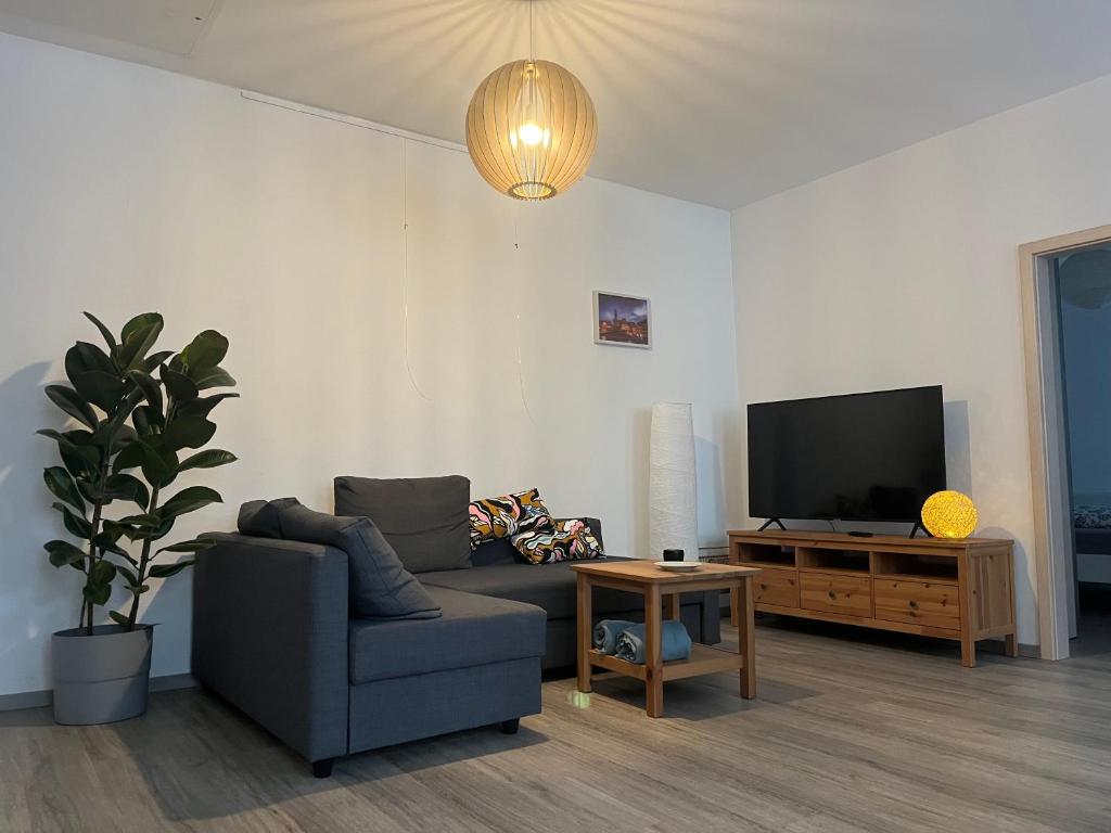 a living room with a couch and a tv at Bergstadtwohnung in Freiberg