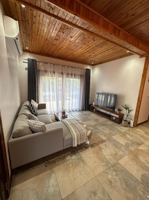a living room with a couch and a television at Jumba paradise in Mtwapa