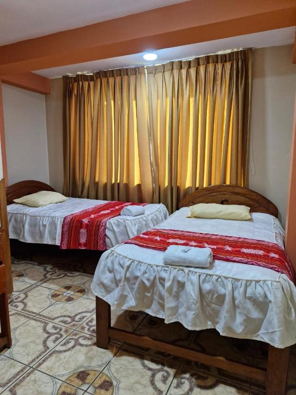 Postel nebo postele na pokoji v ubytování Hotel Colquewasi