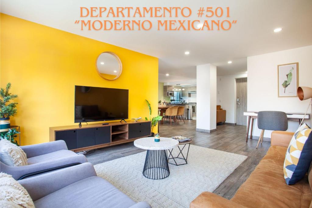 a living room with a couch and a tv at Corazón de Condesa 3 departamentos - 200Mbps WiFi, Roof, Gym in Mexico City