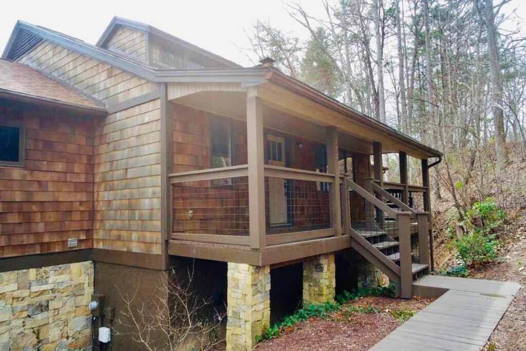 a house with a large deck on the side of it at Entire 3 Bedroom Home in Rumbling Bald Resort in Lake Lure