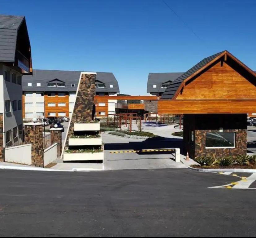 a group of buildings with stairs in a parking lot at Laghetto Resort Golden Gramado in Gramado