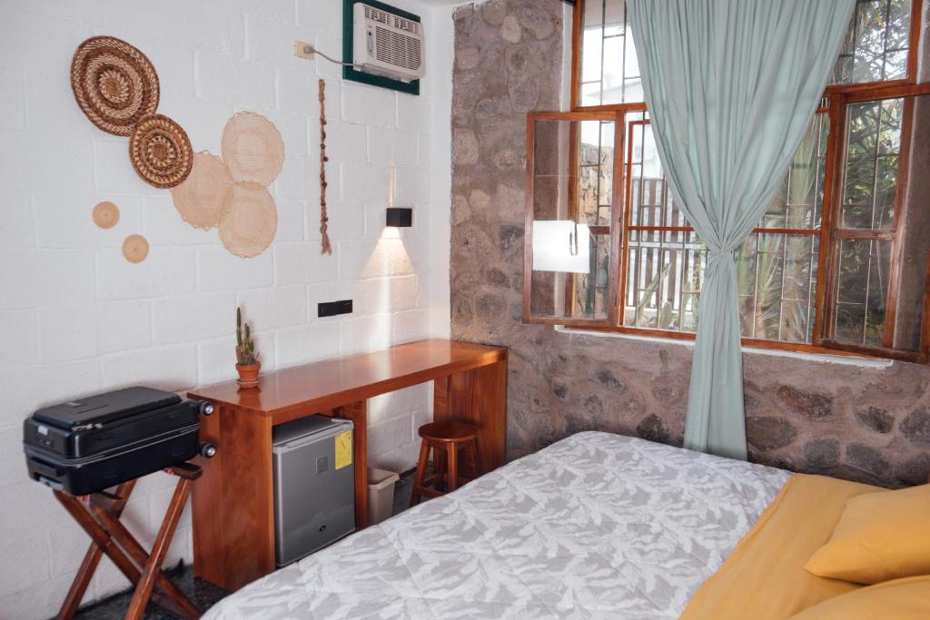 Postel nebo postele na pokoji v ubytování Hostal Pimampiro