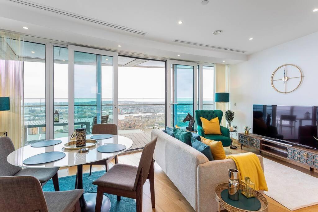 ein Wohnzimmer mit einem Sofa und einem Tisch in der Unterkunft Panoramic balcony luxury condo in London