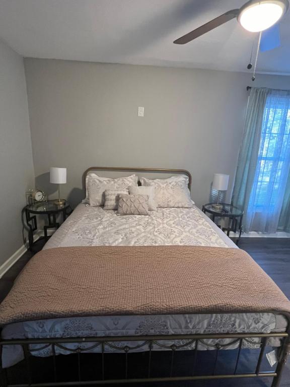 a bedroom with a large bed with two night stands at The Central Crib in Kansas City
