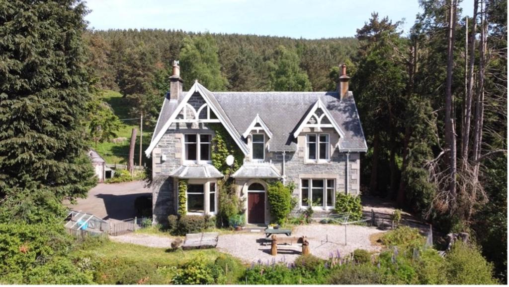 a house in the middle of a forest at Ardchoile, Cairngorms - Escape Cottages Scotland in Kingussie