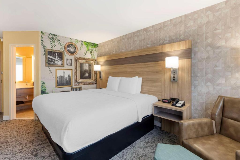 a hotel room with a large bed and a couch at Best Western Glenview - Chicagoland Inn and Suites in Glenview