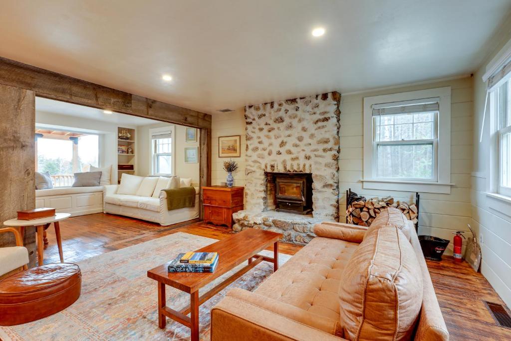a living room with a couch and a fireplace at Expansive Wilmot Escape with Deck Near Skiing! in Wilmot