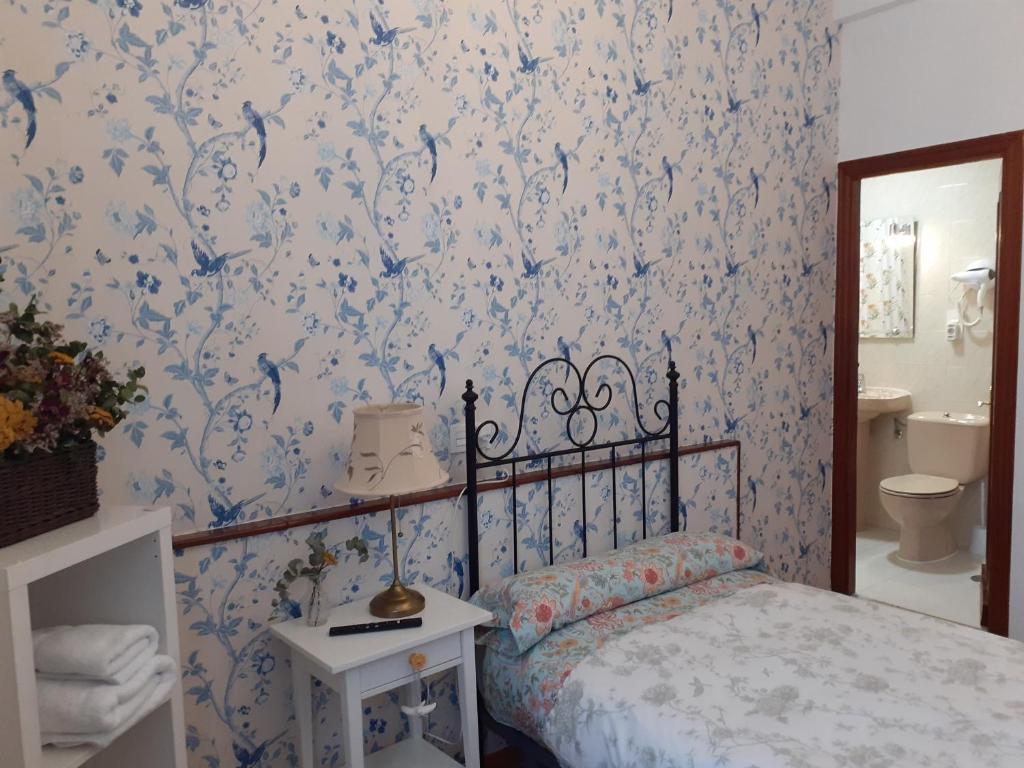 Postel nebo postele na pokoji v ubytování Uría 25 rooms