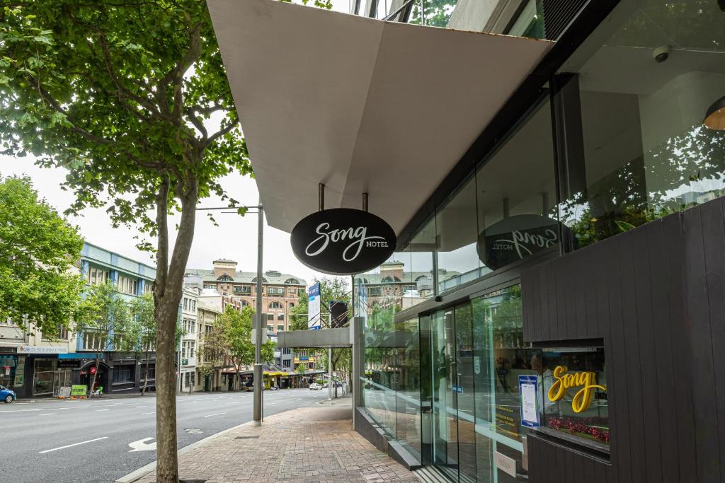 a shop with a sign on the side of a building at Song Hotel Sydney in Sydney
