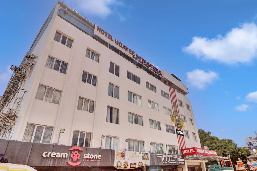 a large white building with a sign on it at Udayee International Hotel in Tirupati
