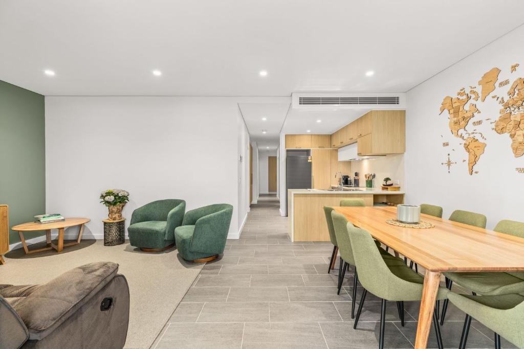 a kitchen and dining room with a table and chairs at Splash by Experience Jervis Bay in Huskisson