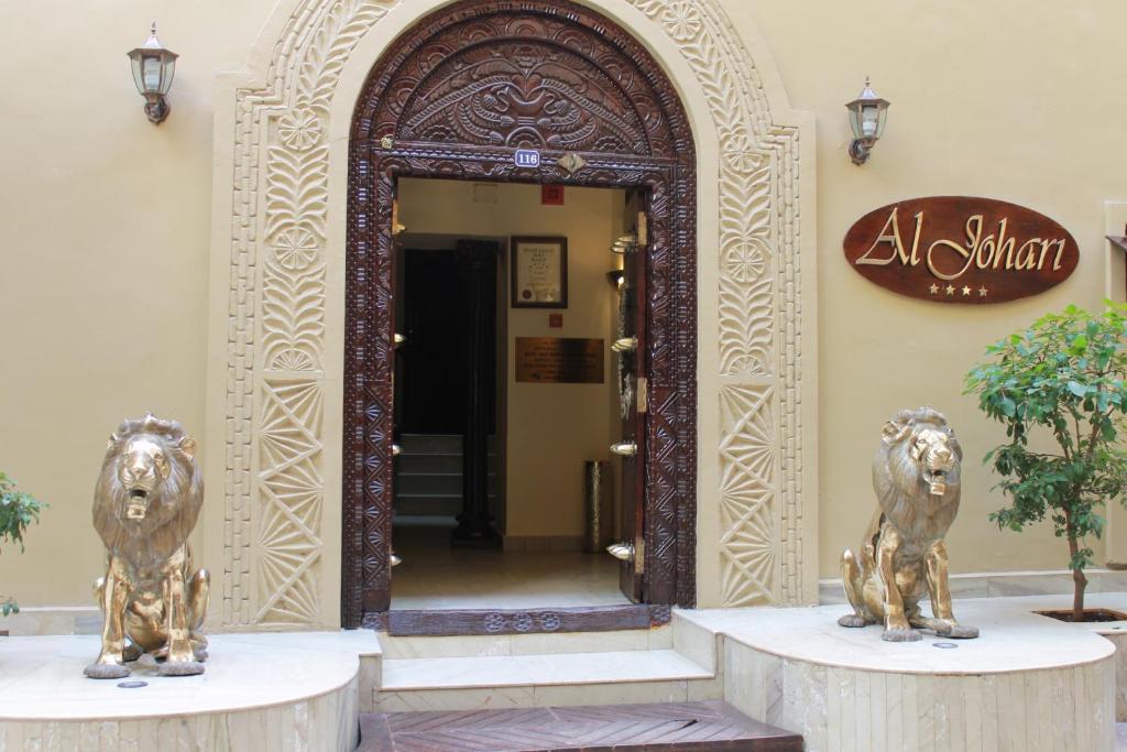 two metal lions in front of an entrance to a building at Al Johari in Zanzibar City