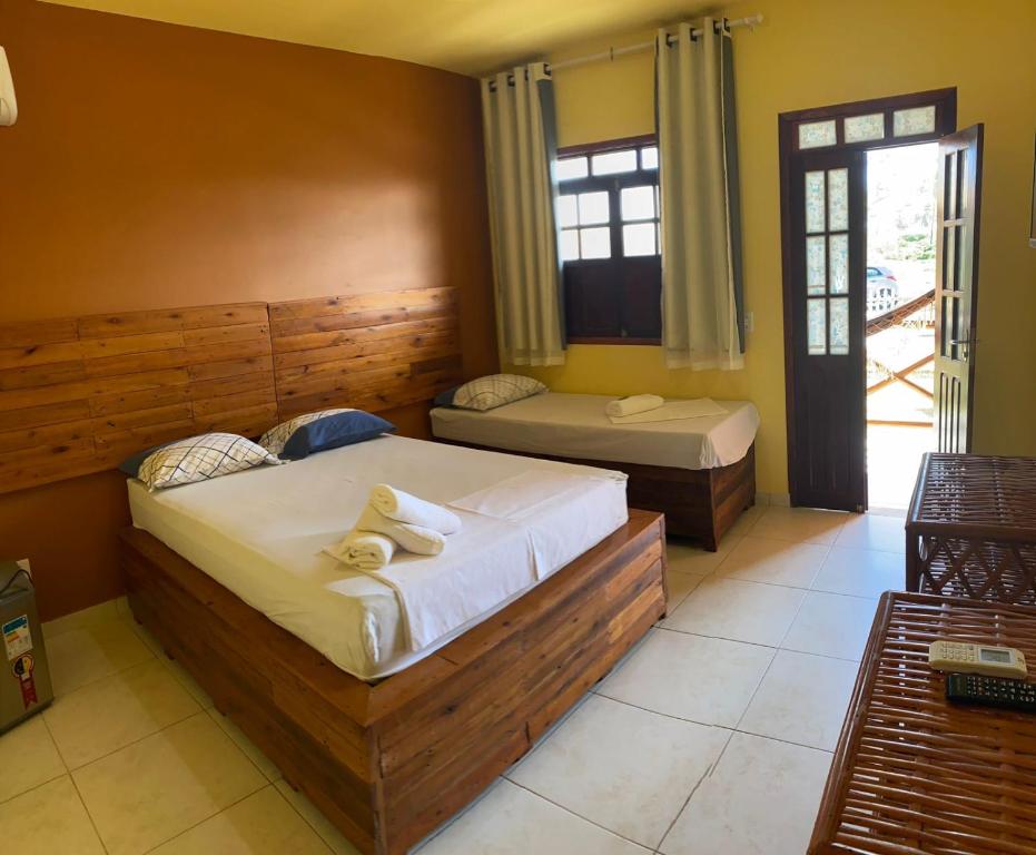 a bedroom with two beds in a room with a window at Águas de Sauípe in Porto de Sauipe