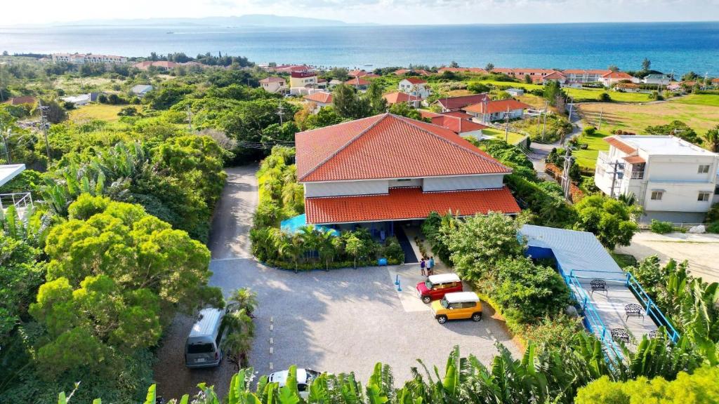 an aerial view of a house with a parking lot at Little Mermaid Hotel Ishigakijima in Ishigaki Island