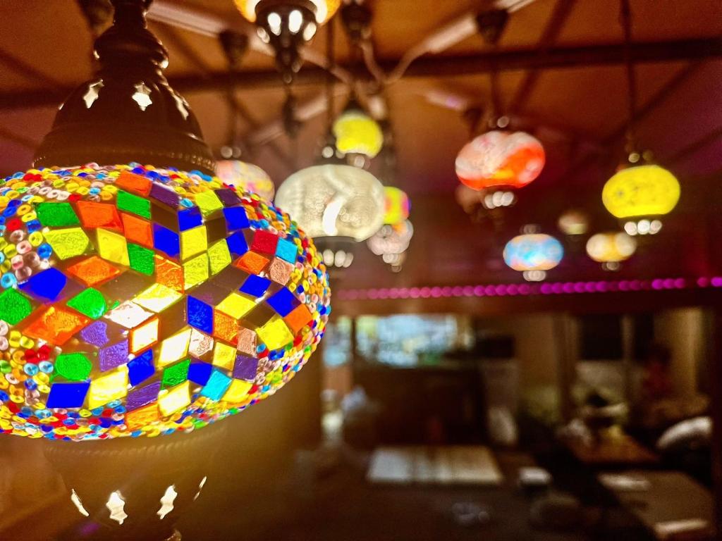 a colorful glass light fixture hanging from a ceiling at HOTEL1800 in Seki