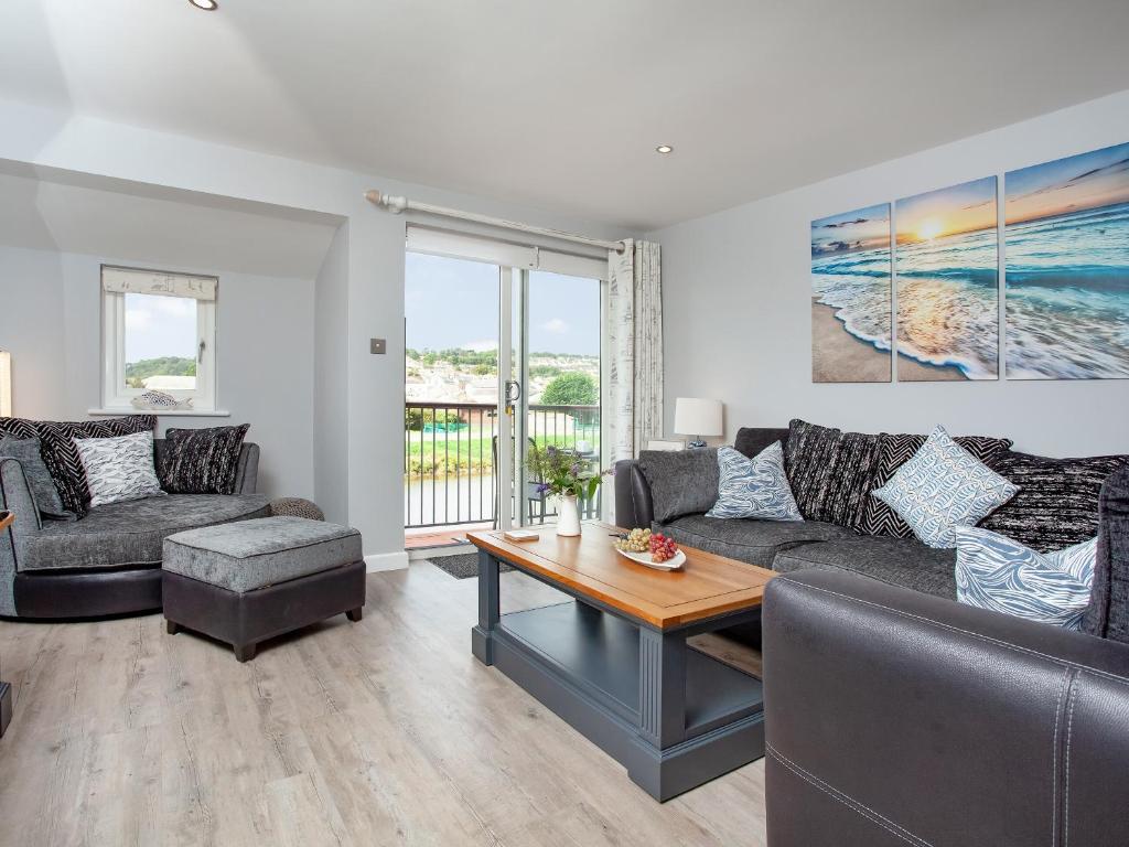 a living room with a couch and a table at 6 Camelside in Wadebridge