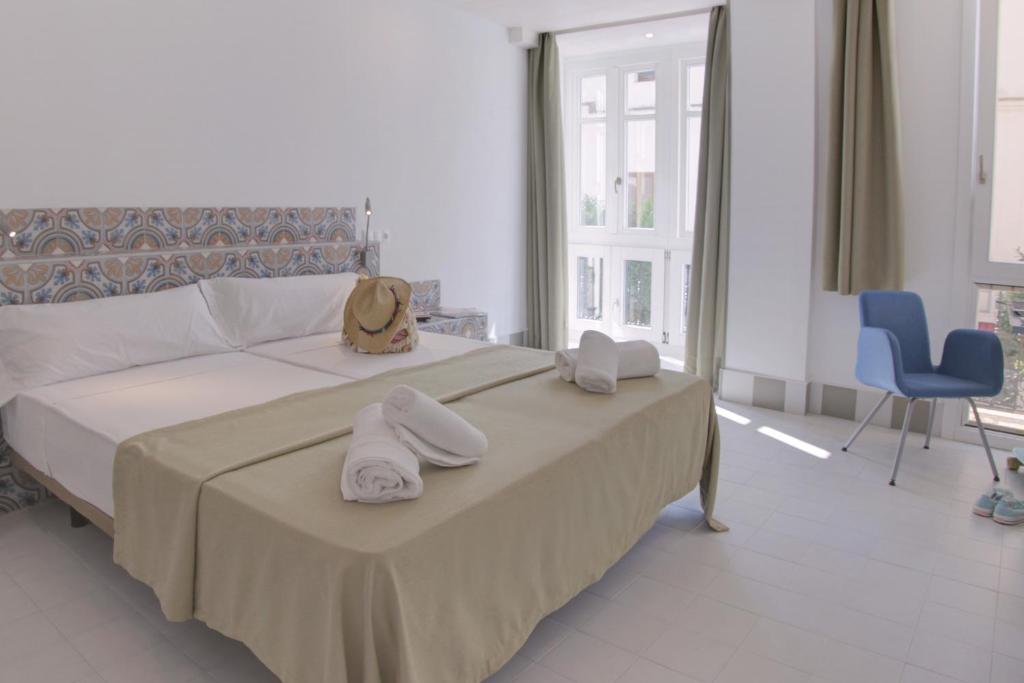 Postel nebo postele na pokoji v ubytování Hostal Gravina