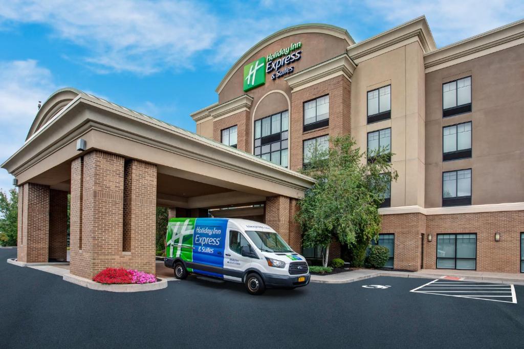a delivery van parked in front of a hotel at Holiday Inn Express Hotel & Suites Rochester Webster, an IHG Hotel in Webster