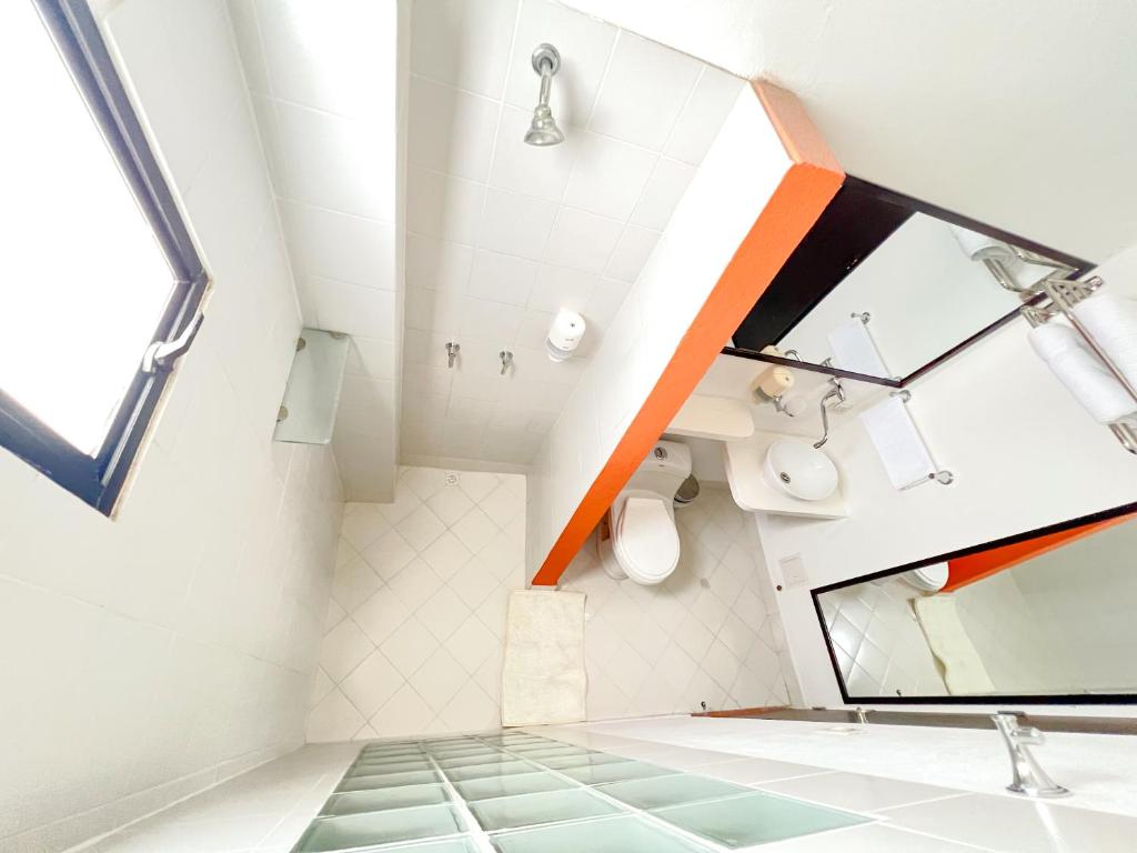 a bathroom with a sink and a mirror at The Orange House Santa Marta in Santa Marta