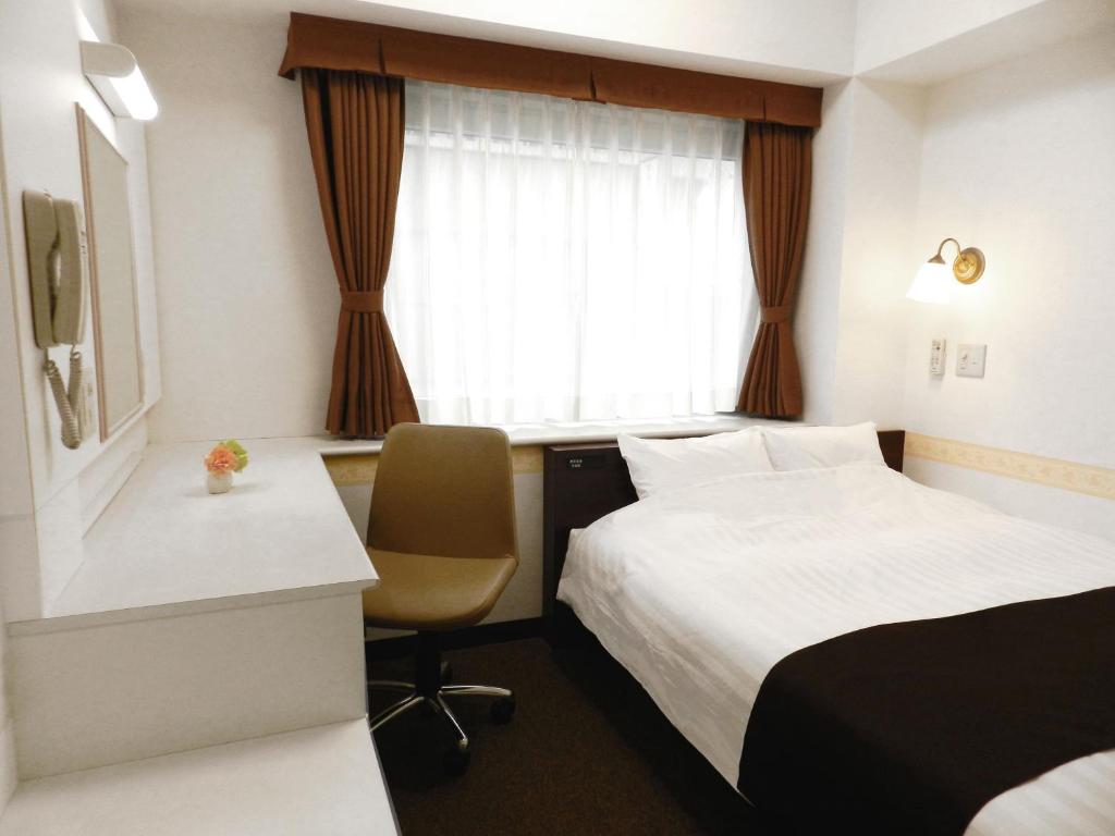Postel nebo postele na pokoji v ubytování Hotel Check In Shimbashi