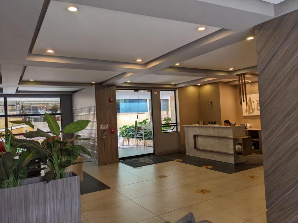 a lobby with a fireplace in a building at Panorama central in Bogotá