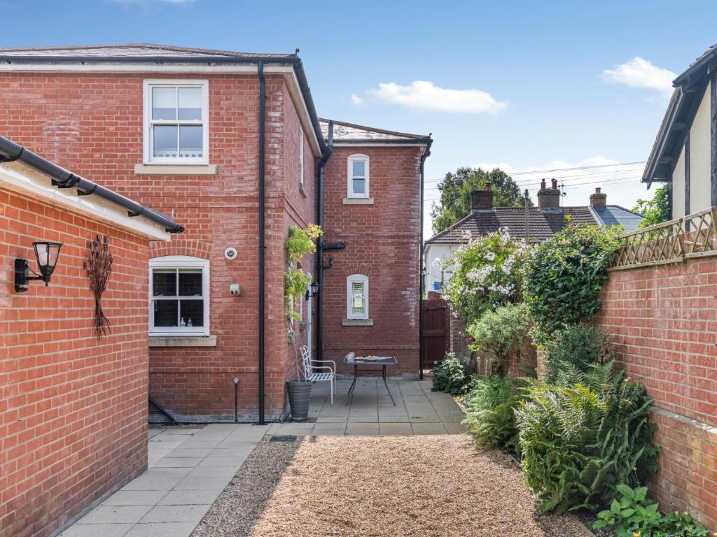 a courtyard of a brick house with a patio at 3 Bed in Christchurch 73946 in Christchurch