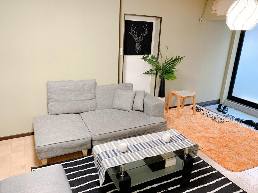 a living room with a couch and a table at Osaka - House - Vacation STAY 9690 in Osaka