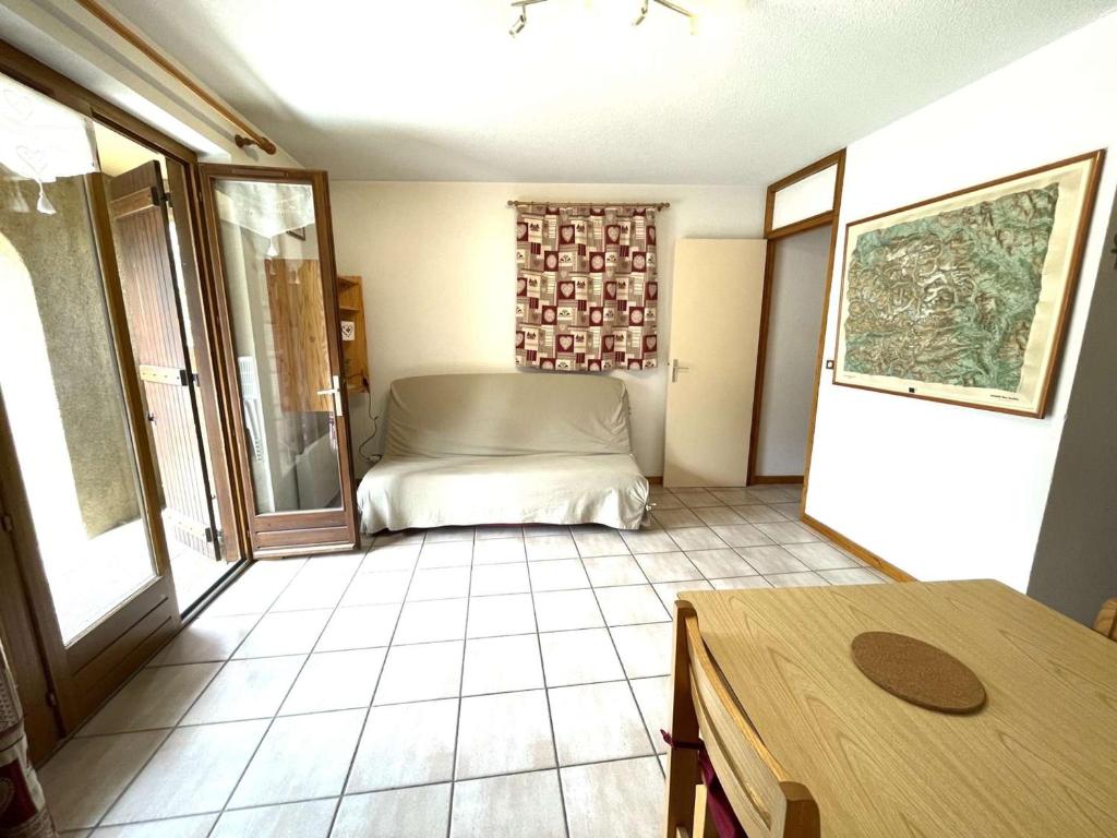 a bedroom with a bed and a table in a room at Appartement Le Monêtier-les-Bains, 2 pièces, 4 personnes - FR-1-330F-225 in Le Reposoir