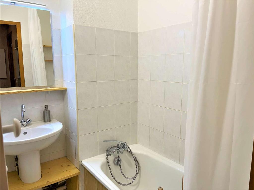 a bathroom with a sink and a shower curtain at Appartement Le Monêtier-les-Bains, 2 pièces, 4 personnes - FR-1-330F-225 in Le Reposoir