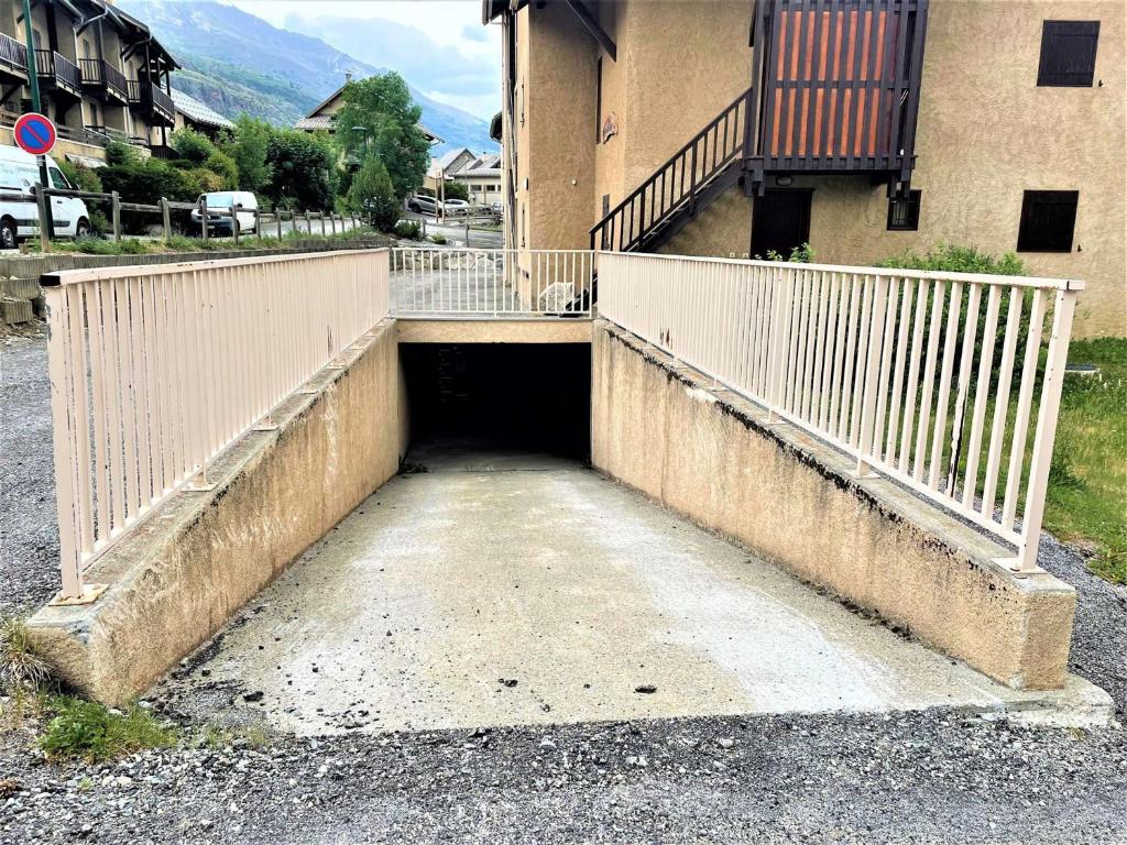 an entrance to a building with a white fence at Appartement Le Monêtier-les-Bains, 2 pièces, 4 personnes - FR-1-330F-225 in Le Reposoir