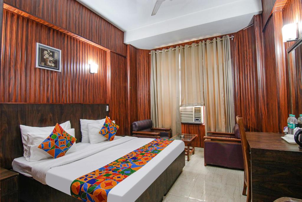 a bedroom with a bed and a desk in a room at FabHotel Prime The Rivlet MG Road in Gurgaon